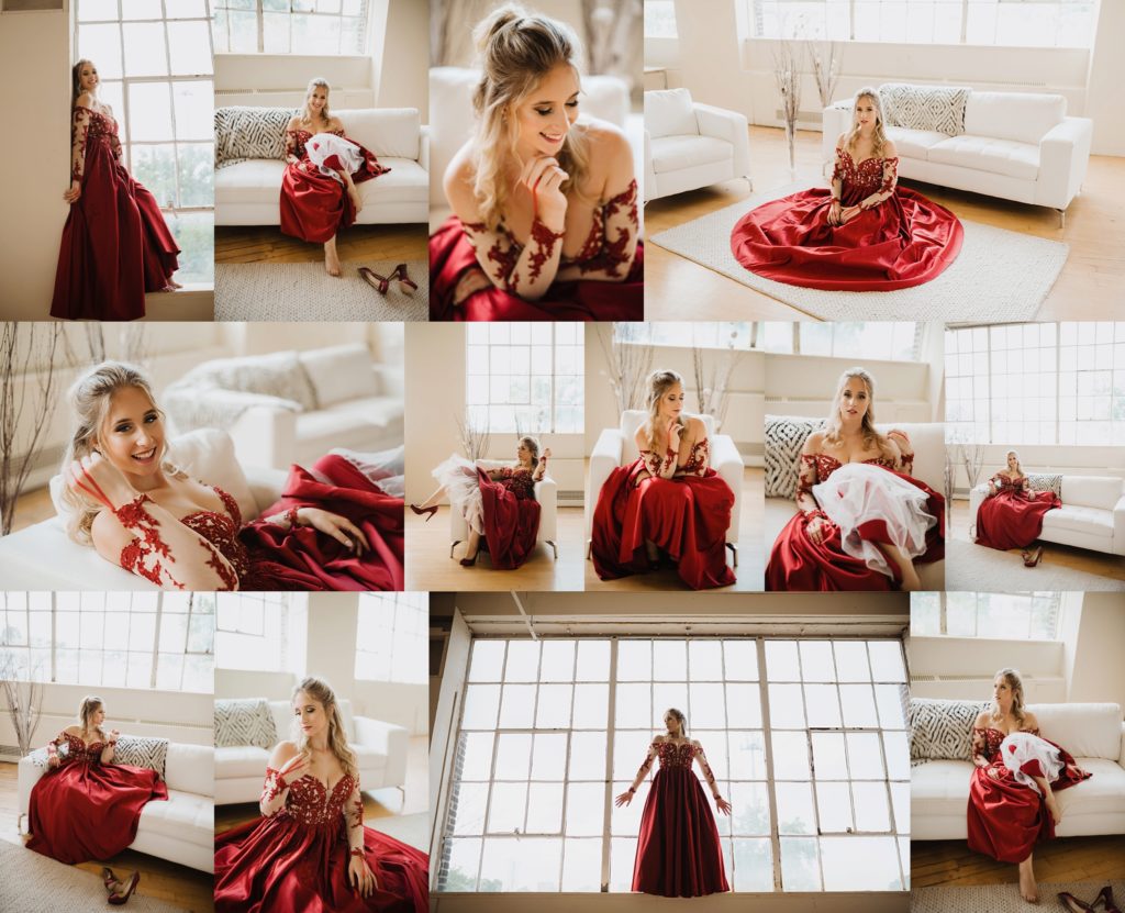 high school senior posing in a natural light studio with large windows in red prom dress for ashley nicolle photography
